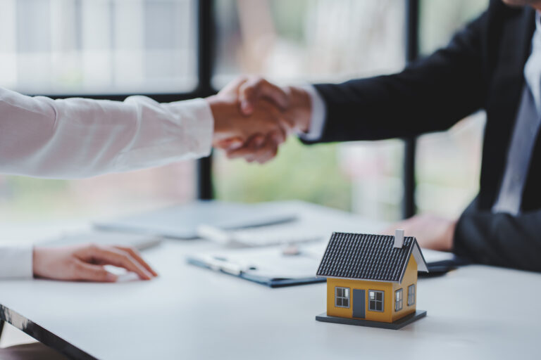 Handshake real estate agents deliver sample homes to customers. mortgage loan agreement Make a contract for hire purchase and sale of a house. and home insurance contracts home mortgage loan concept