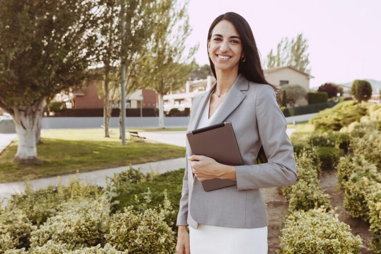 Portrait of urban happy business woman holding and using tablet computer and working. Technology, business, digital tablet concept.
